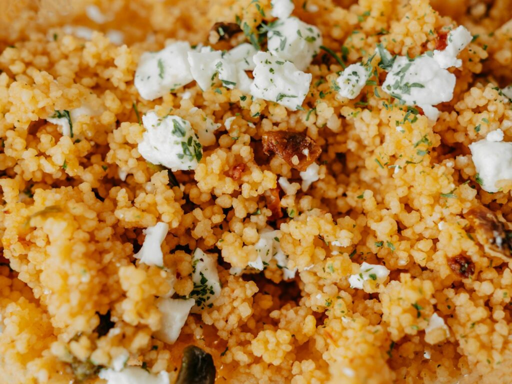 close up of homemade couscous with cheese and herbs