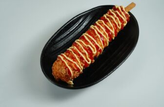 korean corn dog topped with ketchup and mustard