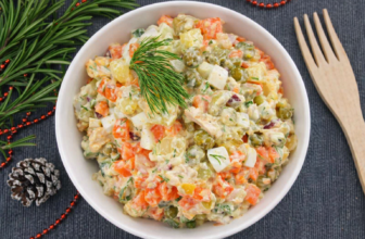 Tigela com salada de maionese colorida contendo cubos de beterraba, cenoura, chuchu e batata envoltos em maionese cremosa.