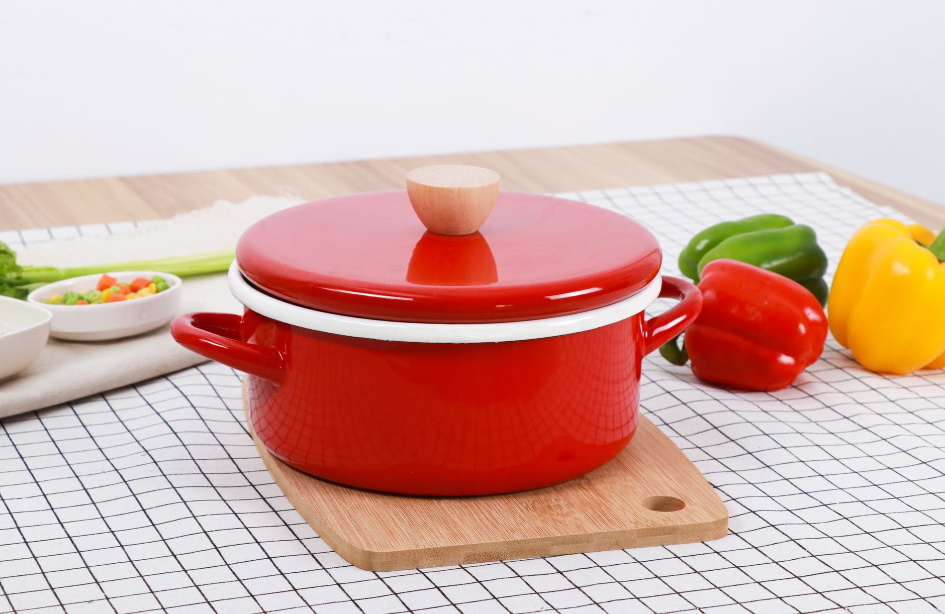 red cooking pot and raw bell peppers